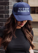 Put It on My Husband's Tab Trucker Hat